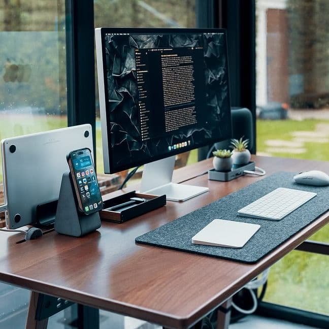 A desk setup beside a large window